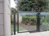 Alumininum and glass gate. The patio/deck railing is a topless glass Infinity rail