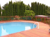 Aluminum and glass railing on a clear cedar pool deck. This project is located in Sedro Woolley WA.