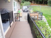 Black aluminum picket railing and matching gate on a Timbertech XLM PVC deck, located in Anacortes, WA.