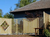 Accent details shocase the bamboo materials. A display of bamboo fencing set up for a garden tour. This yard was a featured garden on the American Rhodadendron Species Foundations tour.